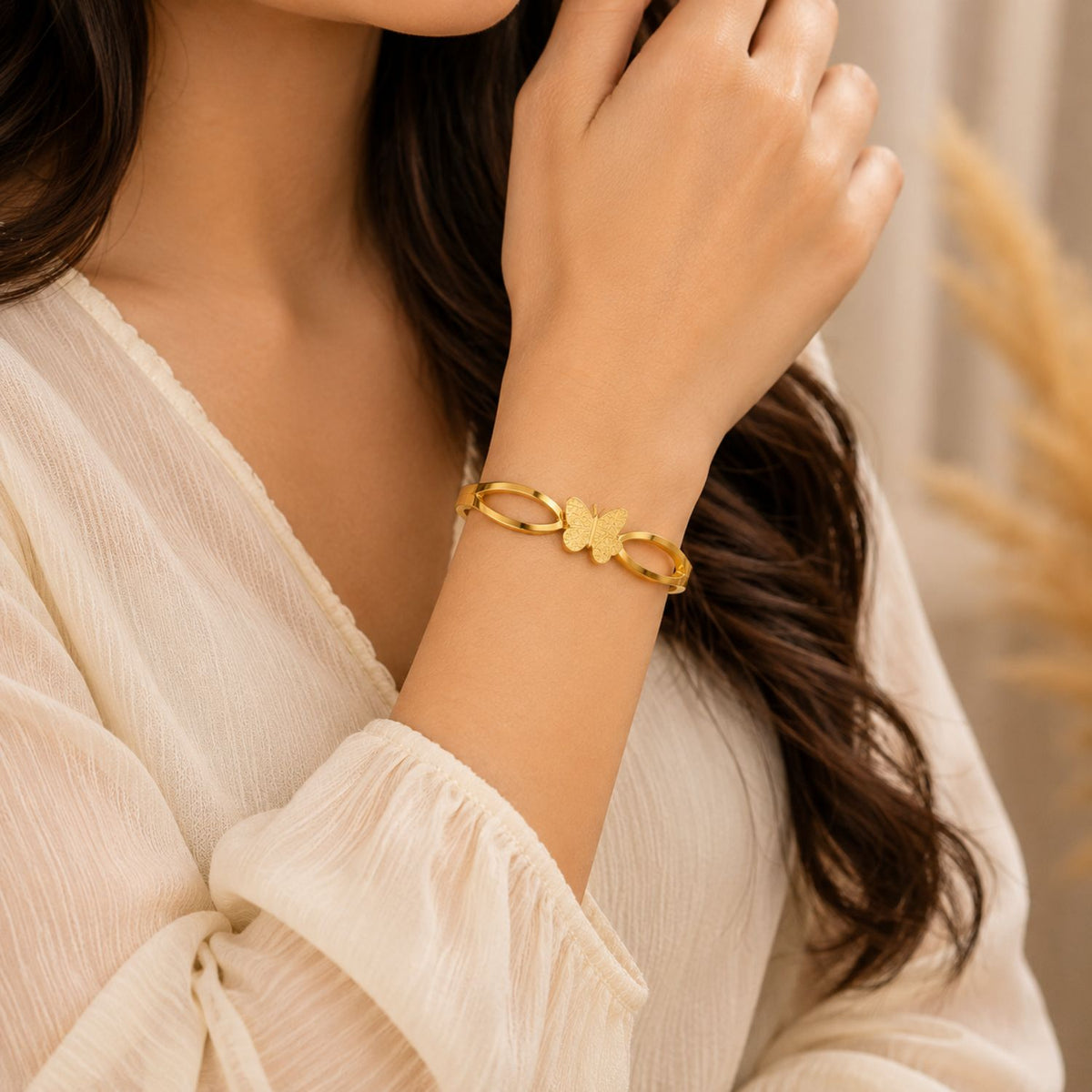 Woman wearing Golden Butterfly Elegance Bangle | Sultan Jewelers