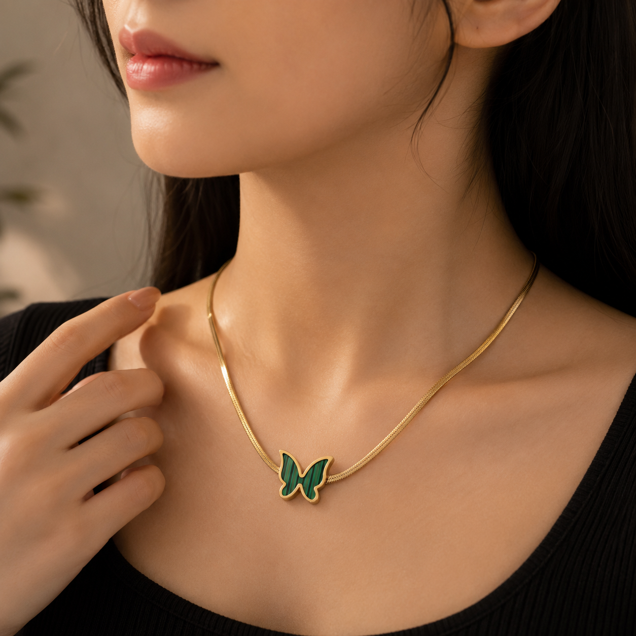 Woman wearing Emerald Butterfly Snake Chain Necklace | Sultan Jewelers